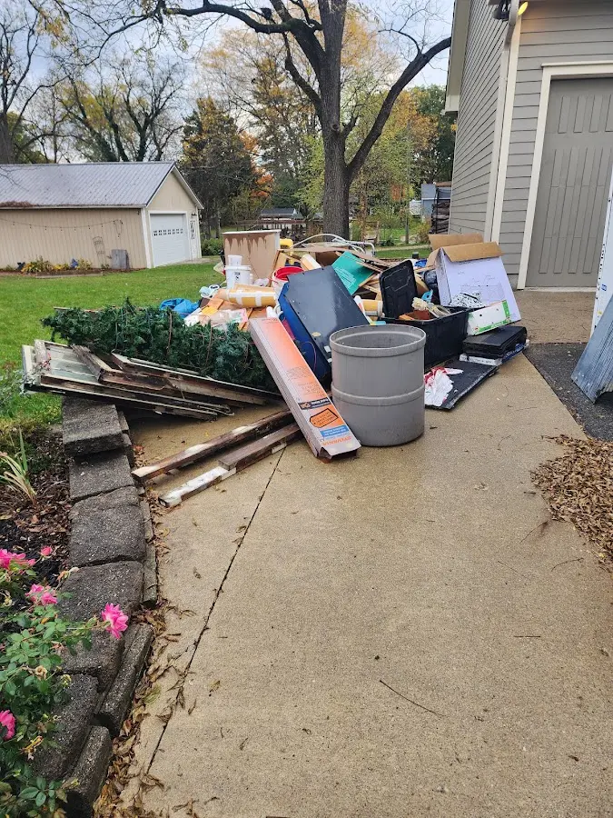 Dumpster being loaded with debris for 12 Yard Dumpster Rental in Machesney Park